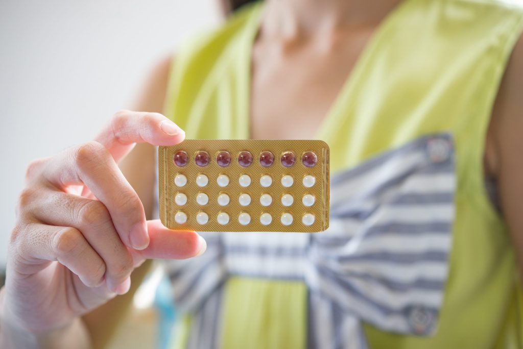 Birth Control 3 woman hand holding contraceptive panel prevent pregnancy scaled 1